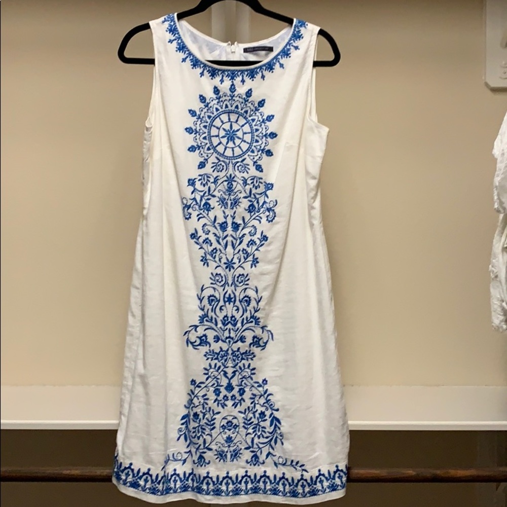 White linen dress with blue embroidery.